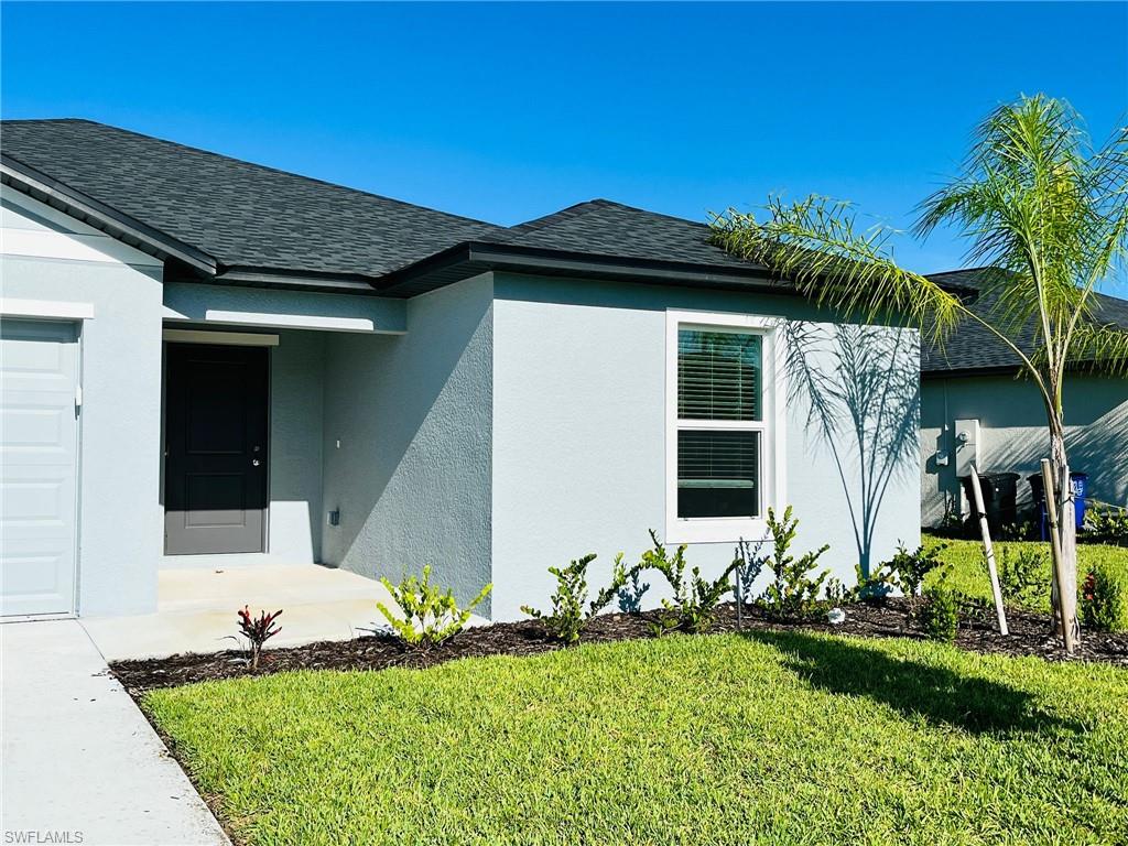 17603 Paradiso Way North Fort Myers, FL 33917 - Photo 23 of 27 a front view of a house with garden