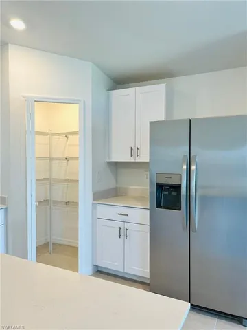a kitchen with a refrigerator and cabinets
