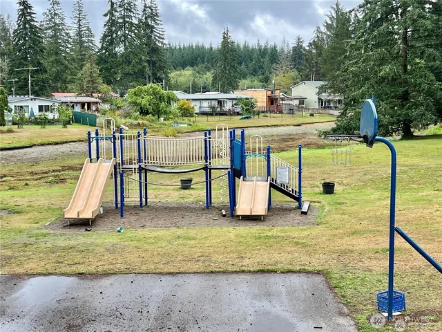 a view of a wooden fence with a house in the background