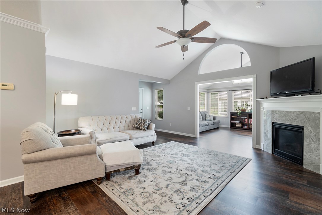 9151 Springfield Road, Unit 1902 Youngstown, OH 44514 - Photo 2 of 36 Living room with a premium fireplace, ceiling fan, dark hardwood / wood-style flooring, and high vaulted ceiling
