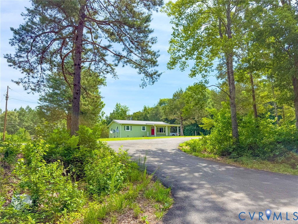 7798 West Courthouse Road Burkeville, VA 23922 - Photo 23 of 23 Paved driveway leading to a residence with a light
