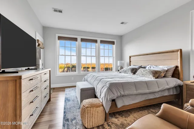 a bedroom with furniture and a flat screen tv