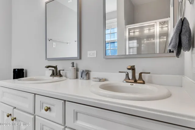 a bathroom with sink and mirror