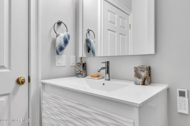 a bathroom with a sink and a mirror