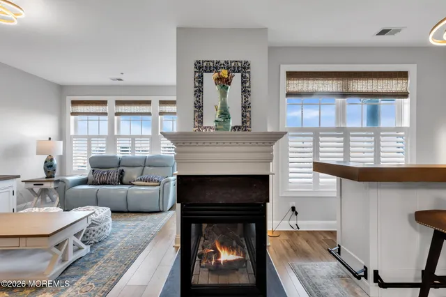 a living room with furniture a fireplace and windows