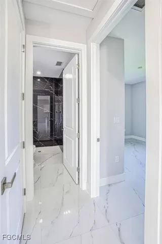 a view of a hallway with wooden shelves