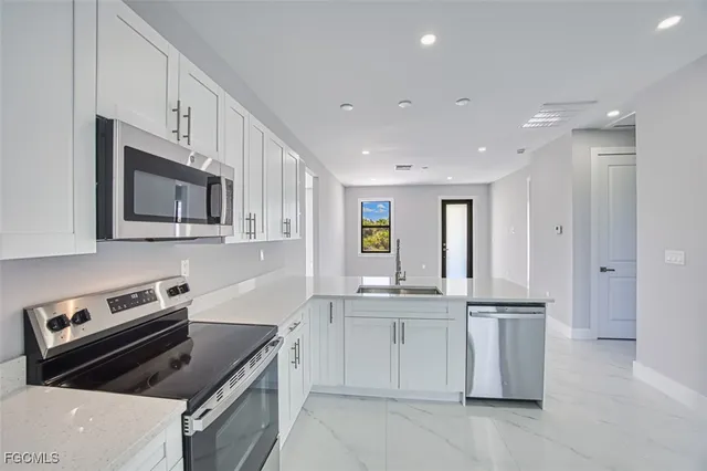 a kitchen that has a sink and a stove