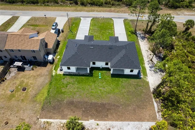 an aerial view of a house with swimming pool garden and patio