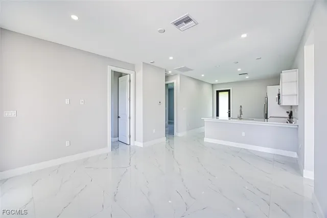 a view of kitchen with refrigerator and window