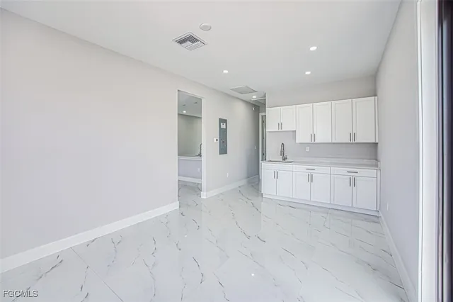 a view of a kitchen with white cabinets