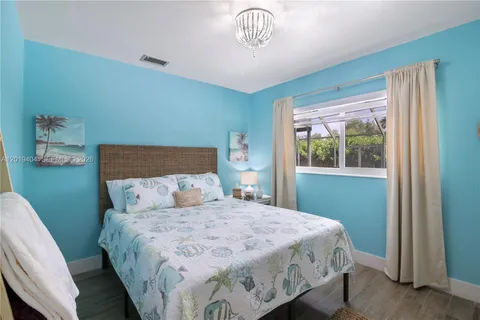 a view of a bedroom with wooden floor and closet