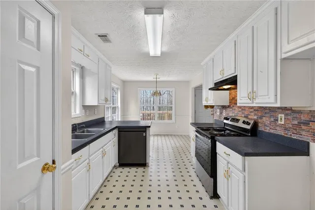 a kitchen with stainless steel appliances a stove a microwave and cabinets