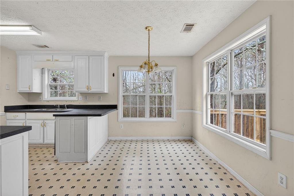 20 Crooked Creek Way Covington, GA 30016 - Photo 23 of 59 a kitchen with a sink a window and cabinets