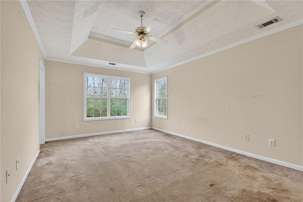 20 Crooked Creek Way Covington, GA 30016 - Photo 27 of 59 an empty room with windows and chandelier fan