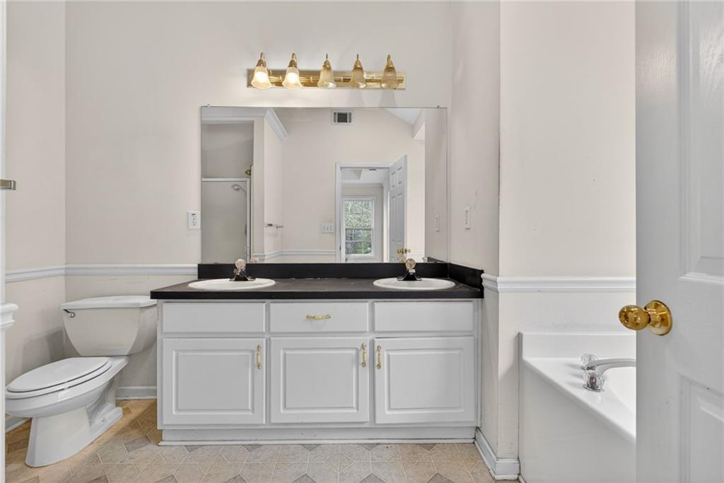 20 Crooked Creek Way Covington, GA 30016 - Photo 30 of 59 a bathroom with a sink and a toilet