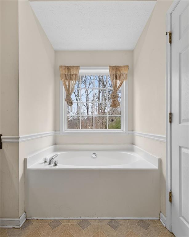 20 Crooked Creek Way Covington, GA 30016 - Photo 31 of 59 a bathroom with a bathtub and window