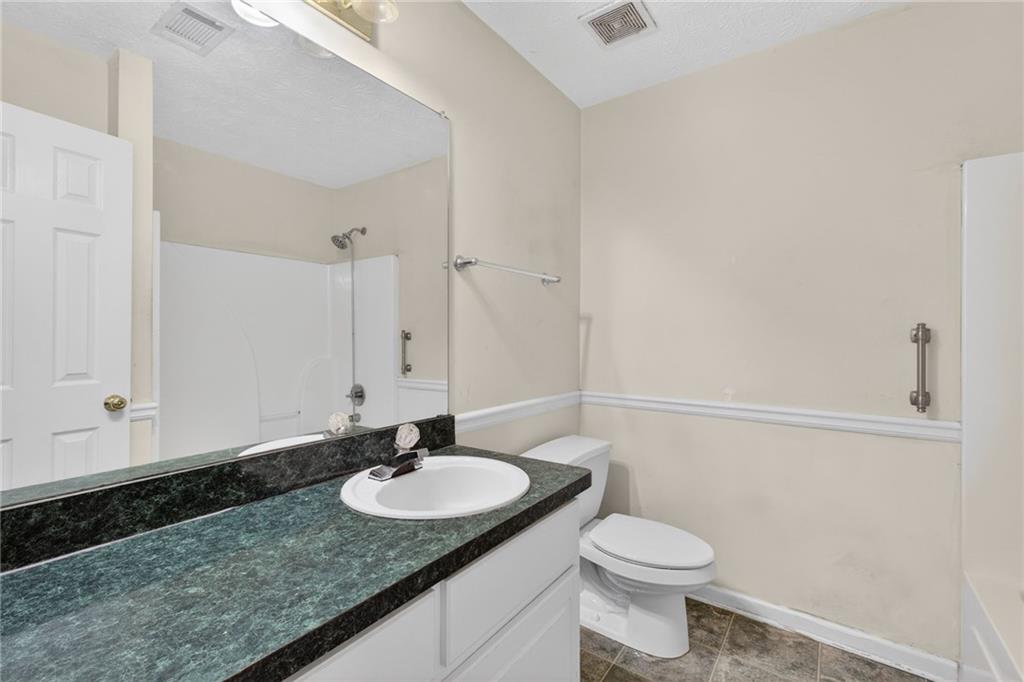 20 Crooked Creek Way Covington, GA 30016 - Photo 36 of 59 a bathroom with a granite countertop sink toilet and a mirror