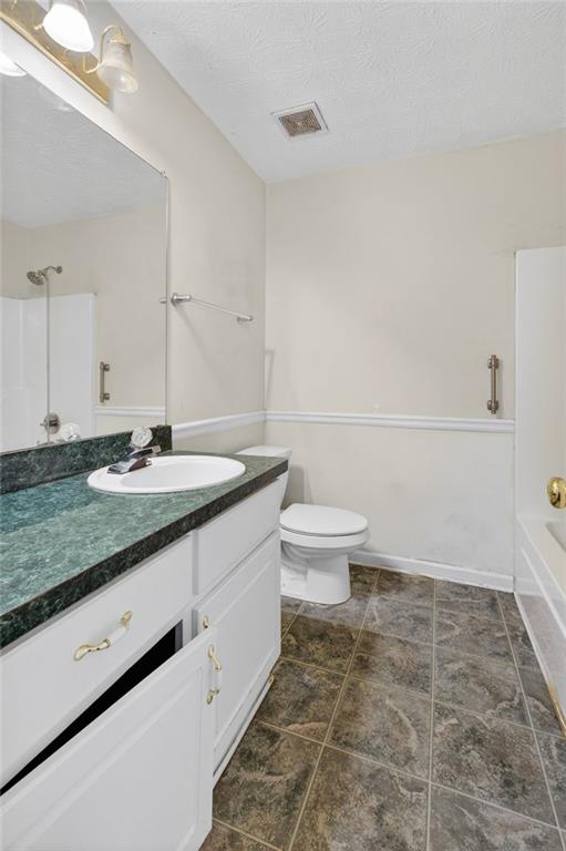 20 Crooked Creek Way Covington, GA 30016 - Photo 37 of 59 a bathroom with a granite countertop sink a toilet and a mirror