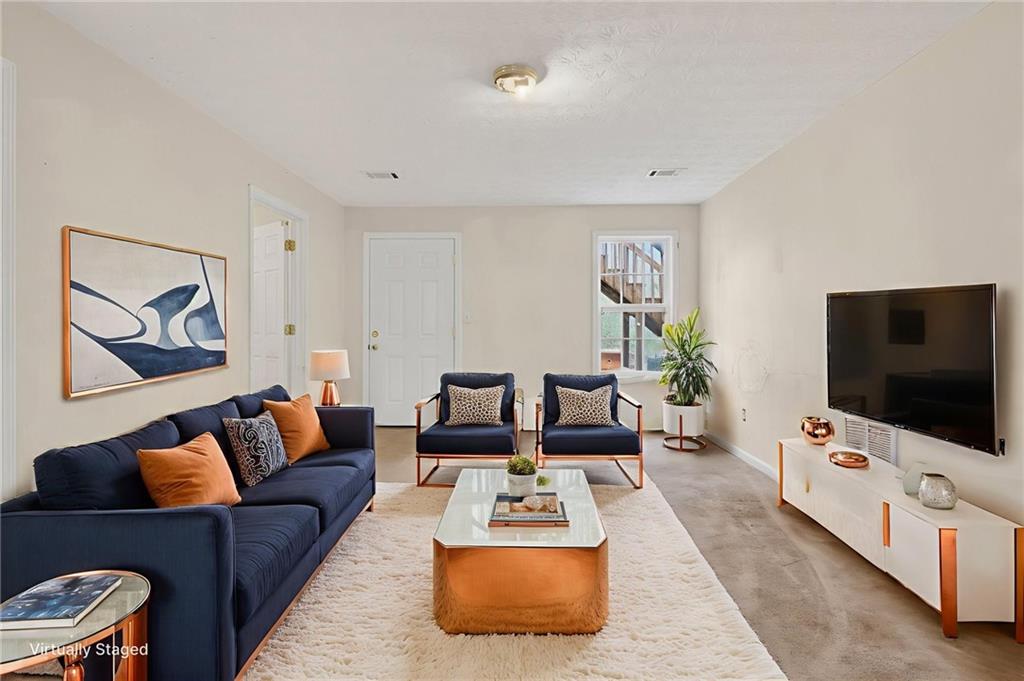 20 Crooked Creek Way Covington, GA 30016 - Photo 41 of 59 a living room with furniture and a flat screen tv