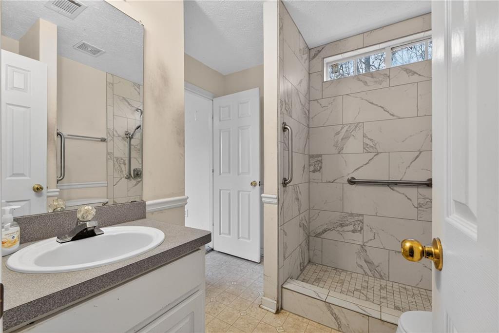 20 Crooked Creek Way Covington, GA 30016 - Photo 44 of 59 a bathroom with a sink and a mirror