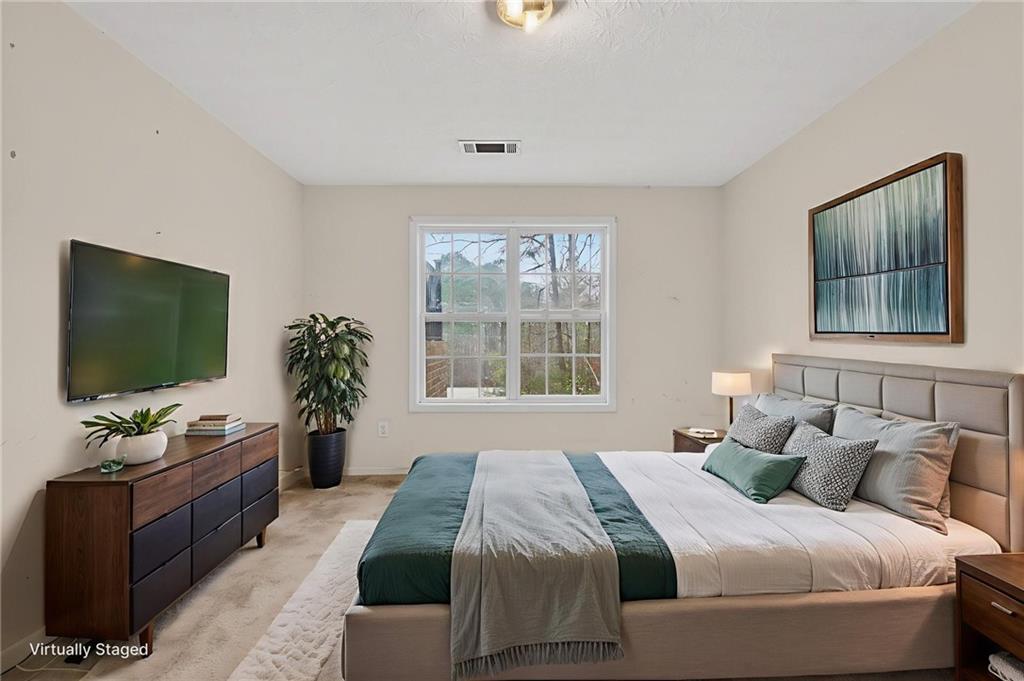 20 Crooked Creek Way Covington, GA 30016 - Photo 45 of 59 a bedroom with a bed and a flat screen tv