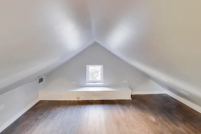 a view of a hallway with wooden floor and closet