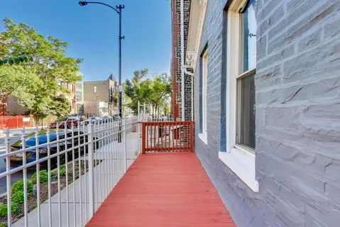 a kitchen with stainless steel appliances a white stove top oven a sink a refrigerator and white cabinets