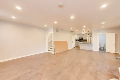 a view of kitchen with kitchen island and stainless steel appliances
