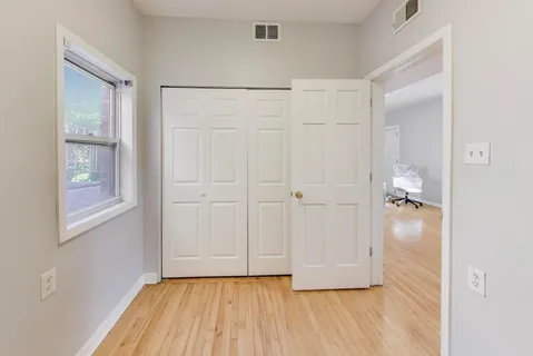 a view of a balcony with wooden floor and fence