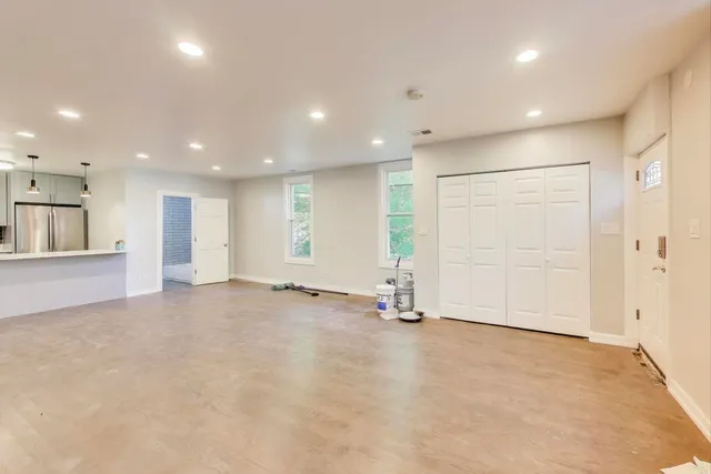 an empty room with cabinet and mirrors