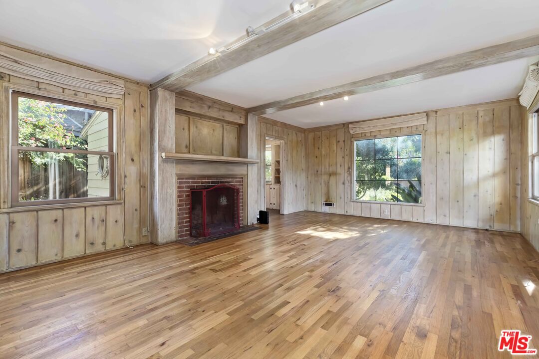 363 West Channel Road Santa Monica, CA 90402 - Photo 4 of 21 a view of an empty room with wooden floor and a window