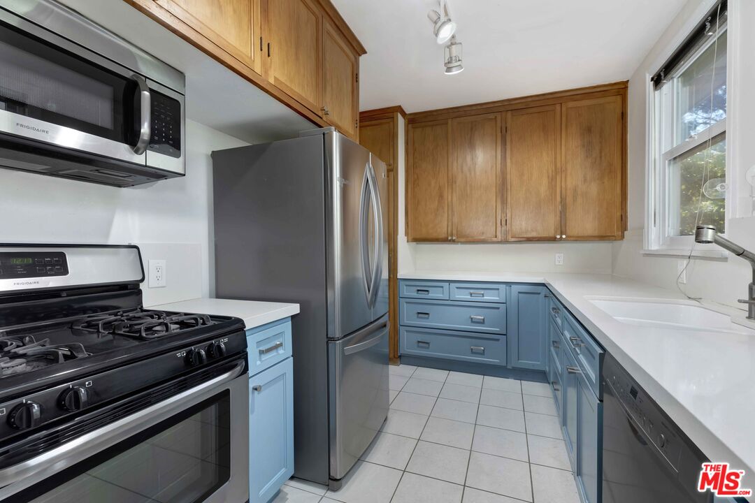 363 West Channel Road Santa Monica, CA 90402 - Photo 9 of 21 a kitchen with stove cabinets and entryway