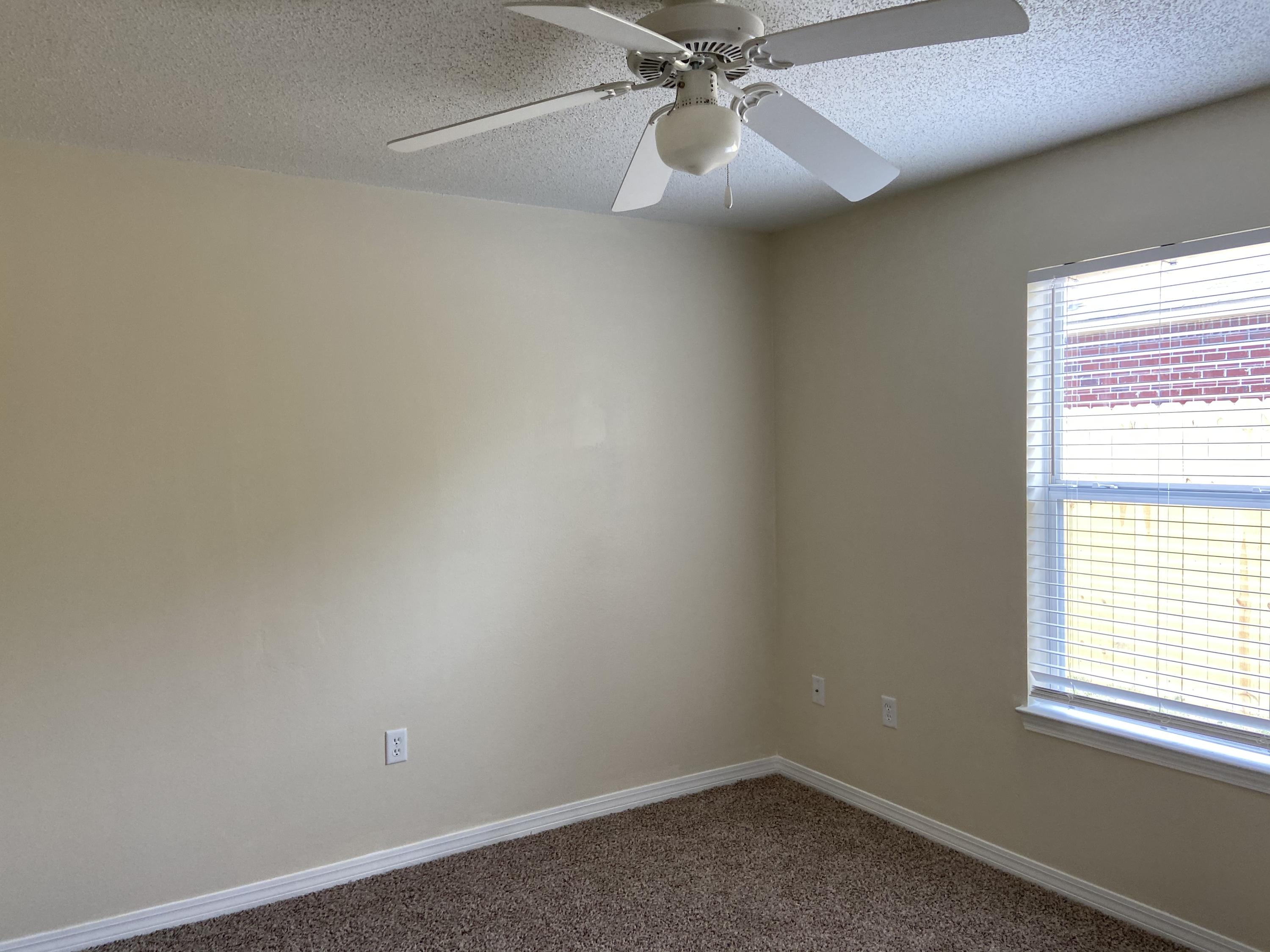 239 Limestone Circle Crestview, FL 32539 - Photo 11 of 15 an empty room with a window and a fan