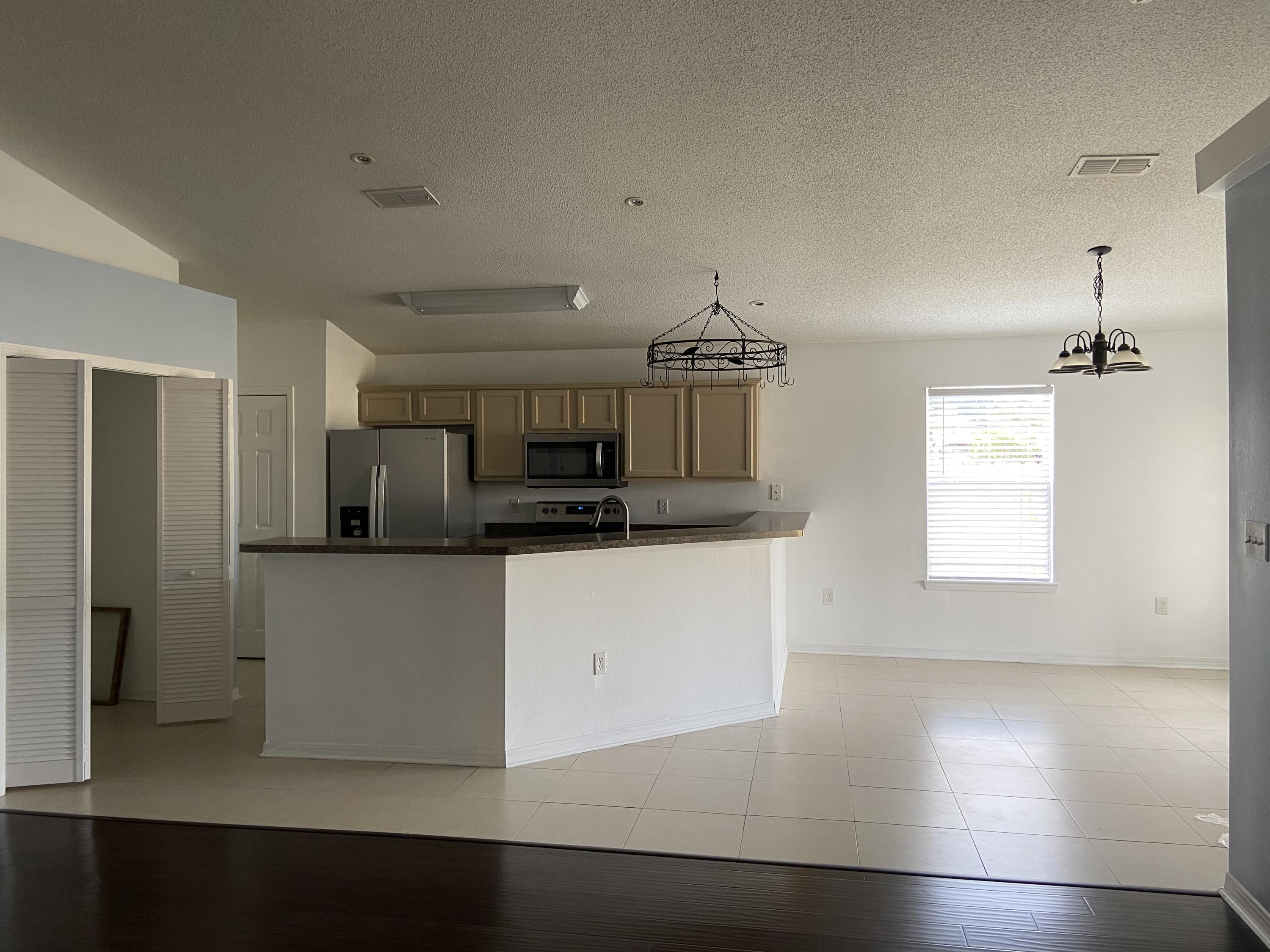 239 Limestone Circle Crestview, FL 32539 - Photo 3 of 15 a kitchen with stainless steel appliances a refrigerator and a stove top oven
