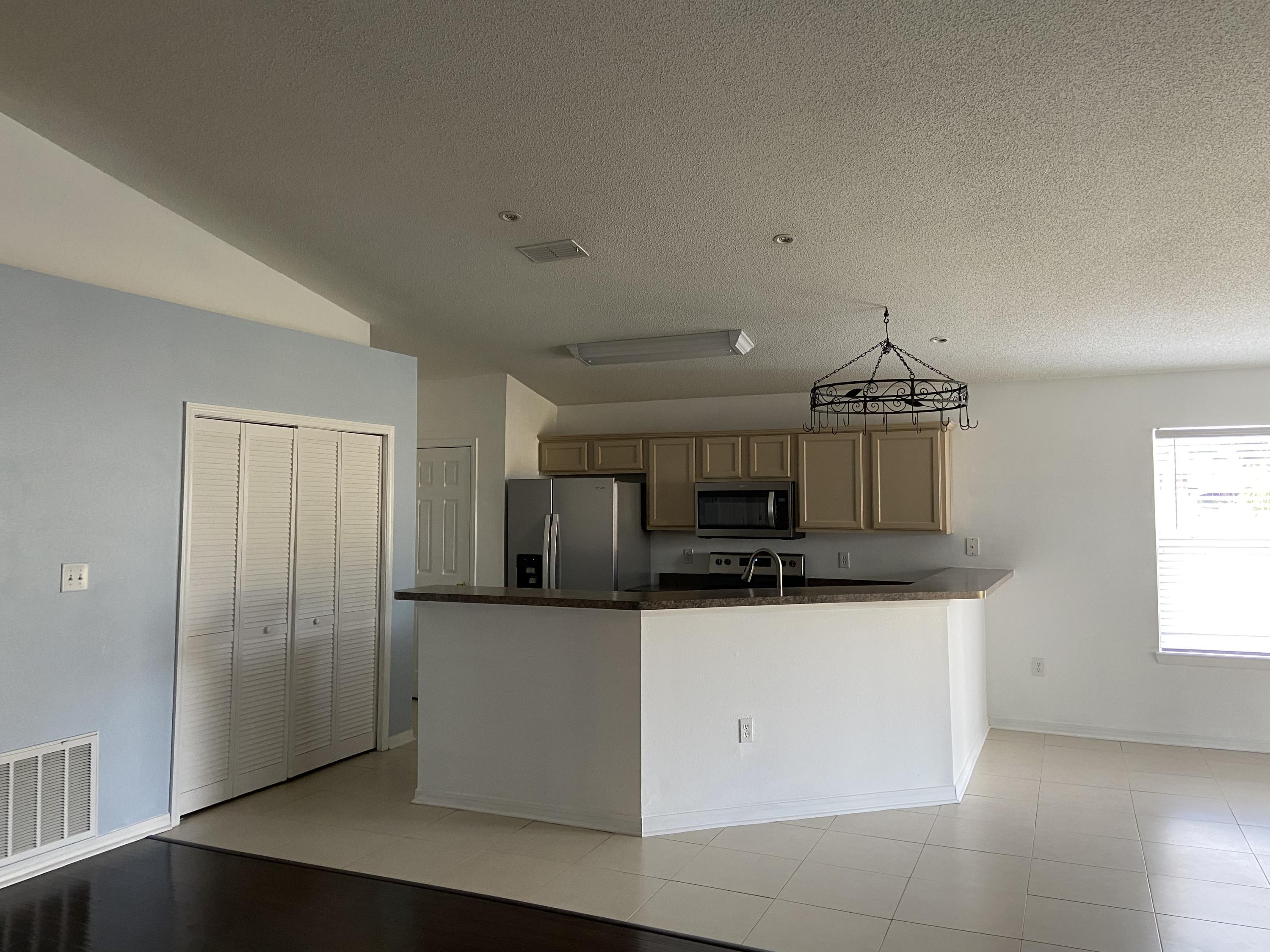 239 Limestone Circle Crestview, FL 32539 - Photo 4 of 15 a kitchen with stainless steel appliances a refrigerator and a stove