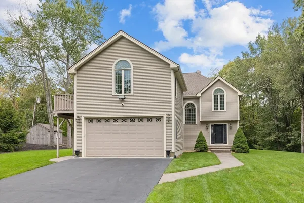 a front view of a house with a yard and garage