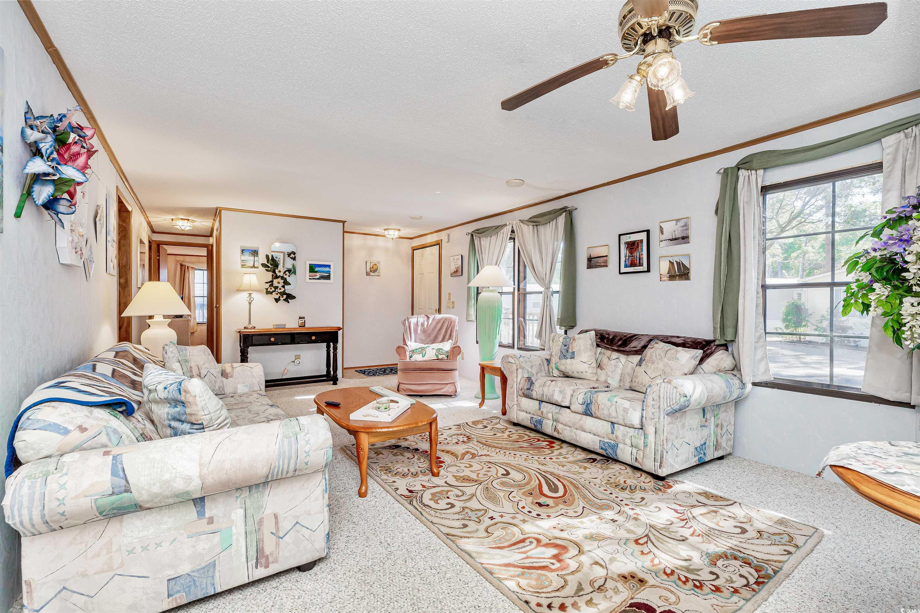 494 Clubhouse Road Murrells Inlet, SC 29576 - Photo 12 of 26 Living room with ornamental molding, a ceiling fan, and a textured ceiling