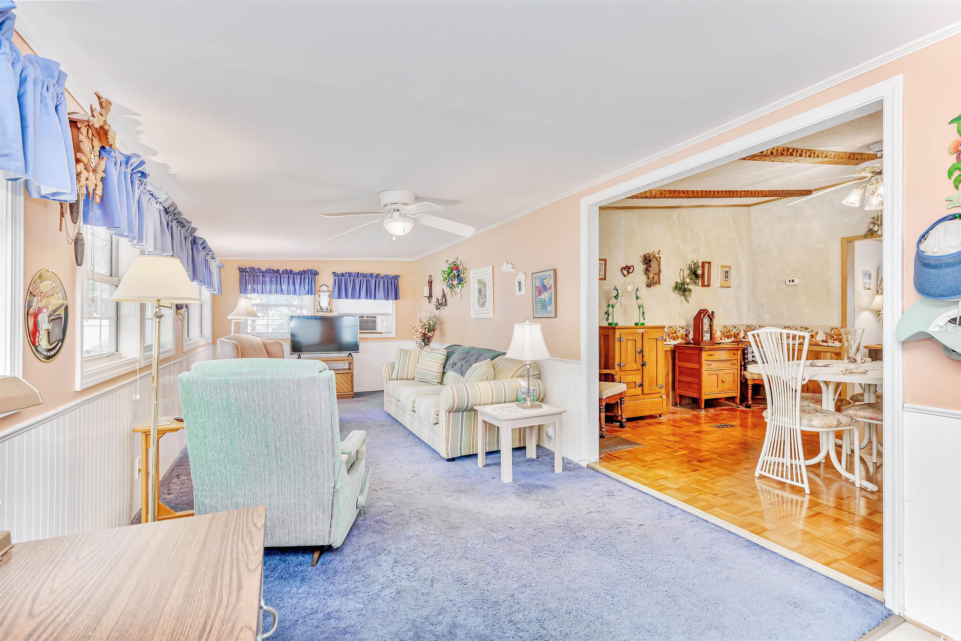 494 Clubhouse Road Murrells Inlet, SC 29576 - Photo 14 of 26 Living area featuring ceiling fan and ornamental molding