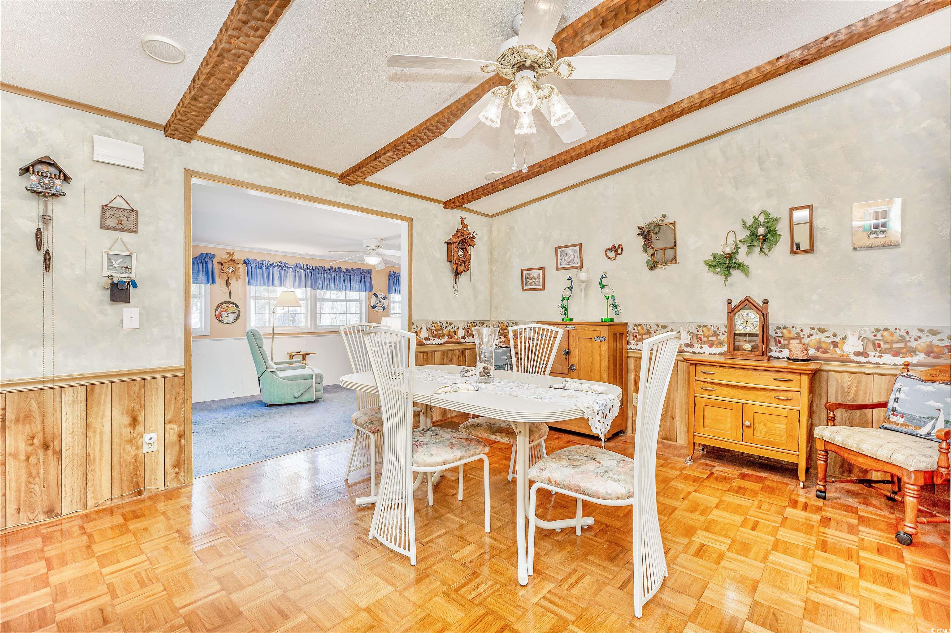 494 Clubhouse Road Murrells Inlet, SC 29576 - Photo 16 of 26 Dining space with ceiling fan, wainscoting, crown molding, and a textured ceiling
