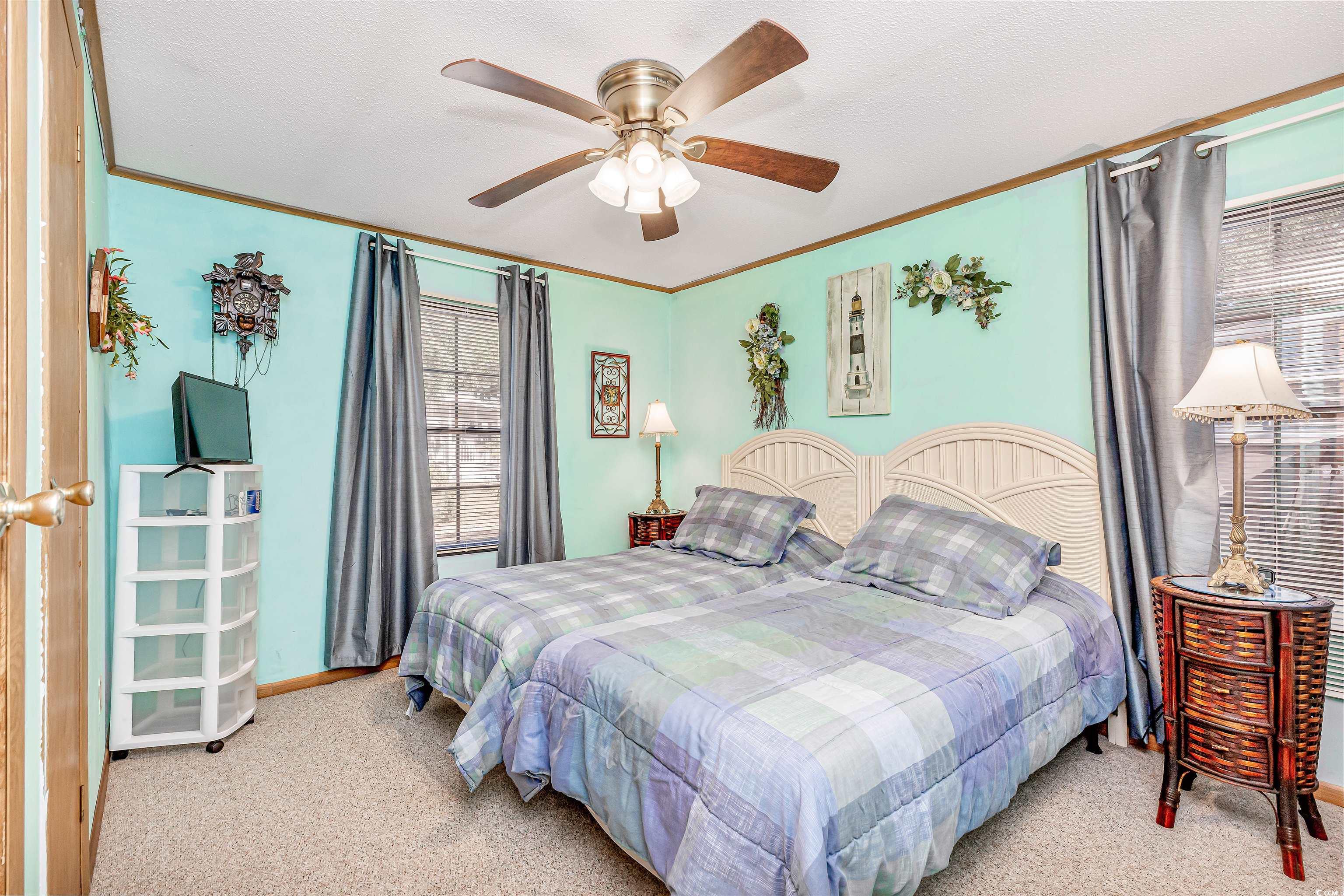494 Clubhouse Road Murrells Inlet, SC 29576 - Photo 19 of 26 Bedroom featuring carpet, crown molding, a ceiling fan, and baseboards