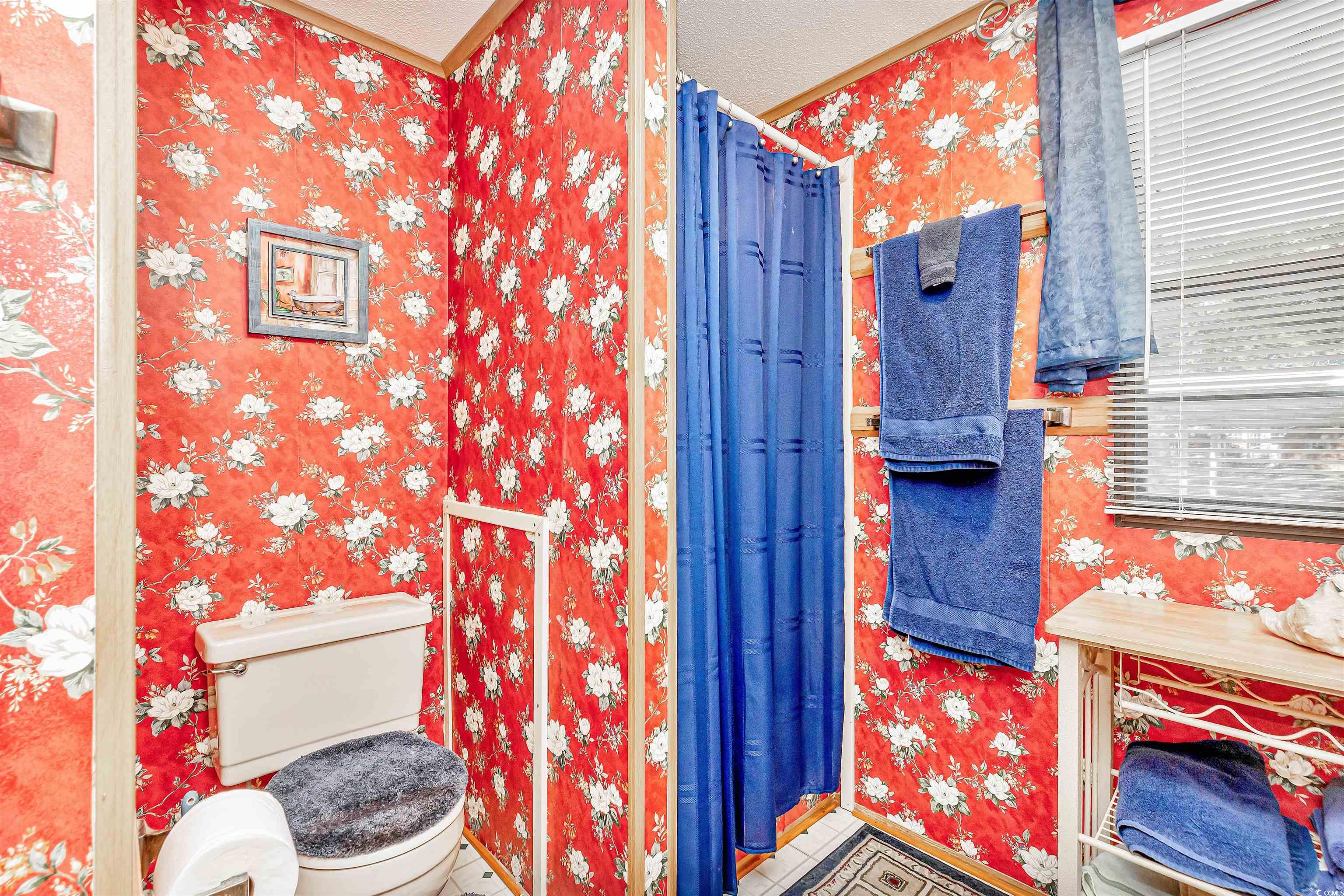 494 Clubhouse Road Murrells Inlet, SC 29576 - Photo 24 of 26 Bathroom featuring wallpapered walls, toilet, crown molding, and a textured ceiling