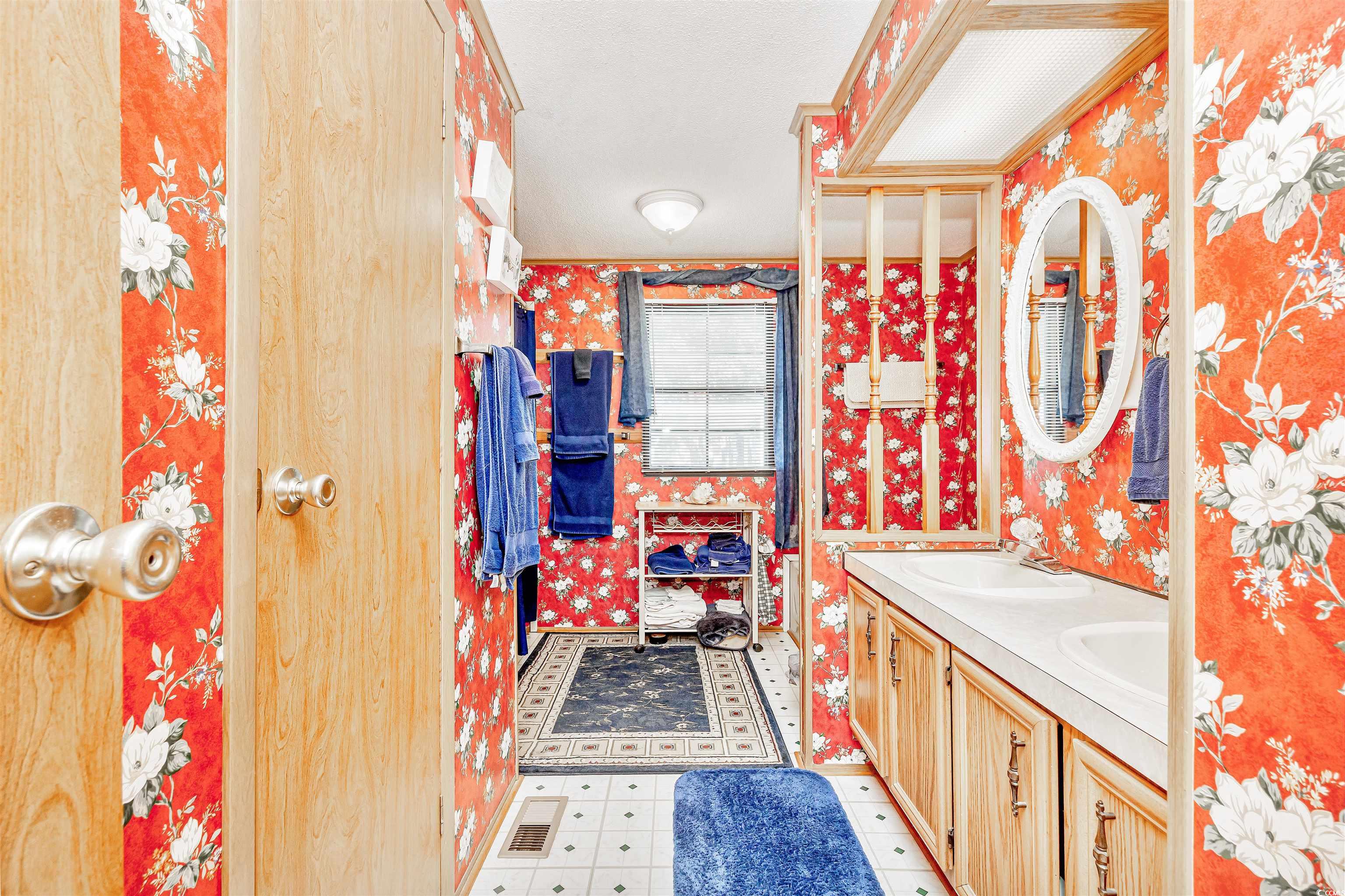 494 Clubhouse Road Murrells Inlet, SC 29576 - Photo 25 of 26 Full bath featuring wallpapered walls, double vanity, tile patterned floors, and ornamental molding