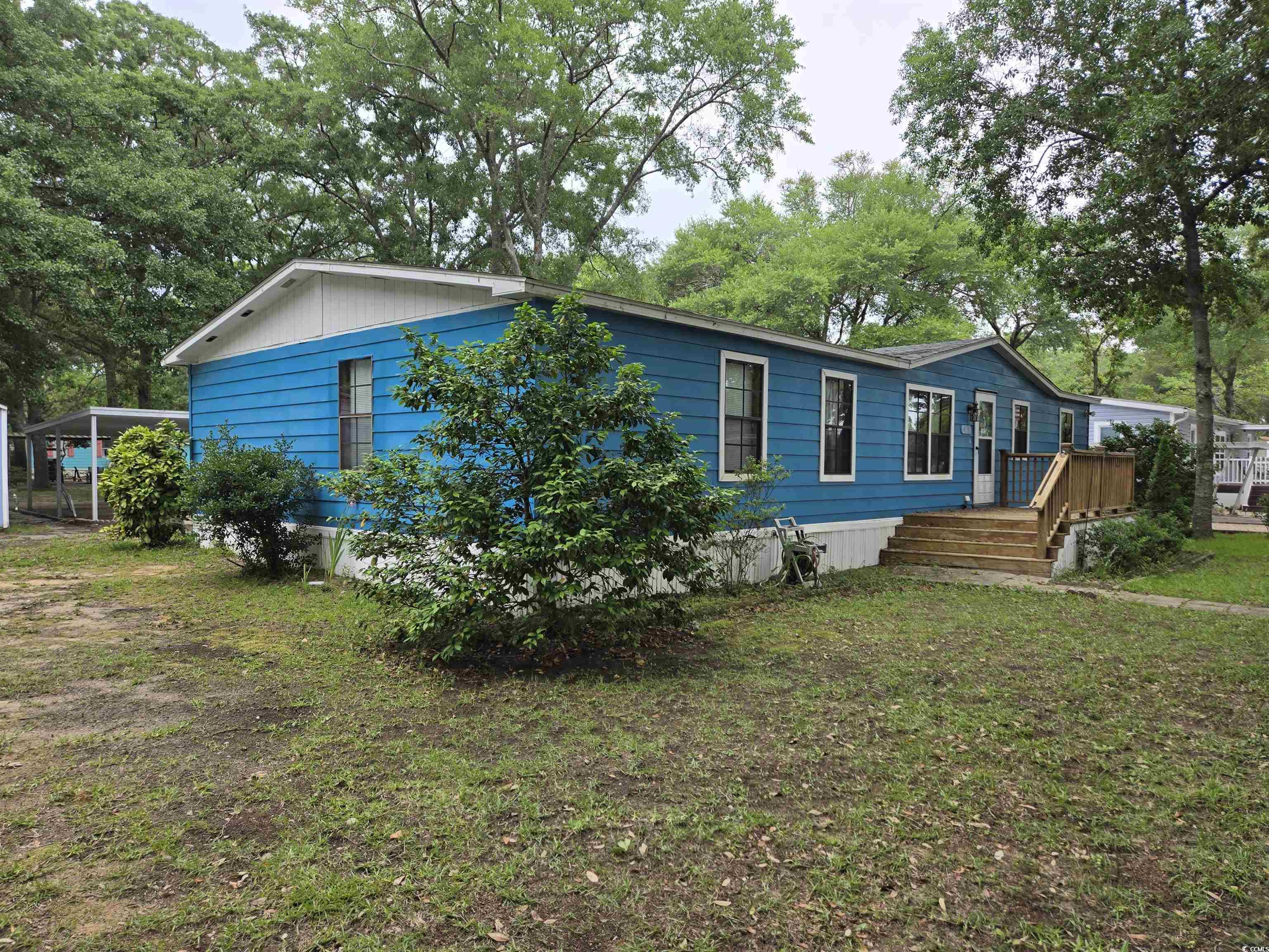 494 Clubhouse Road Murrells Inlet, SC 29576 - Photo 4 of 26 View of front facade featuring a wooden deck and a front lawn