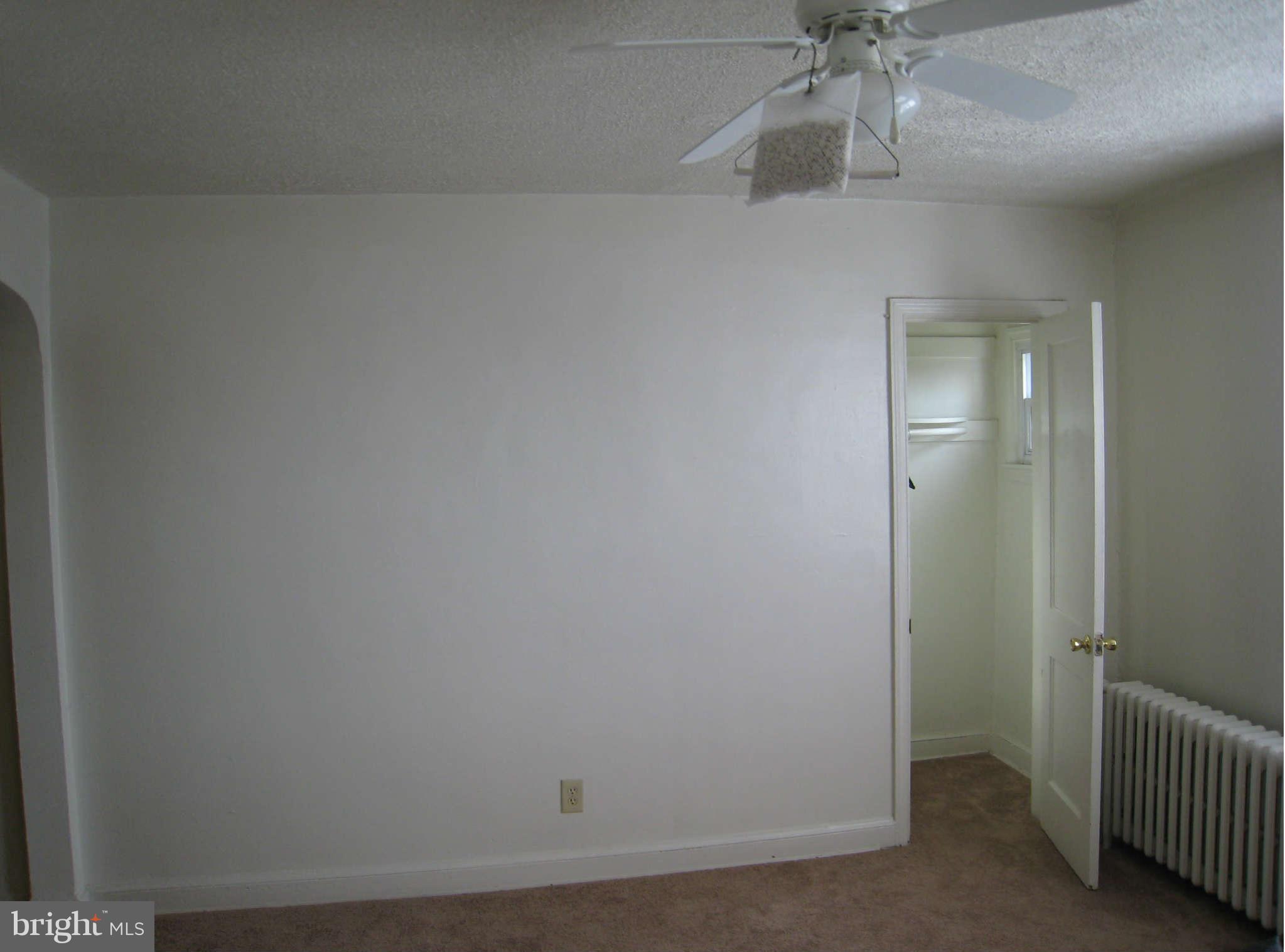 1938 I Street Northeast Washington, DC 20002 - Photo 6 of 18 an empty room with a chandelier fan