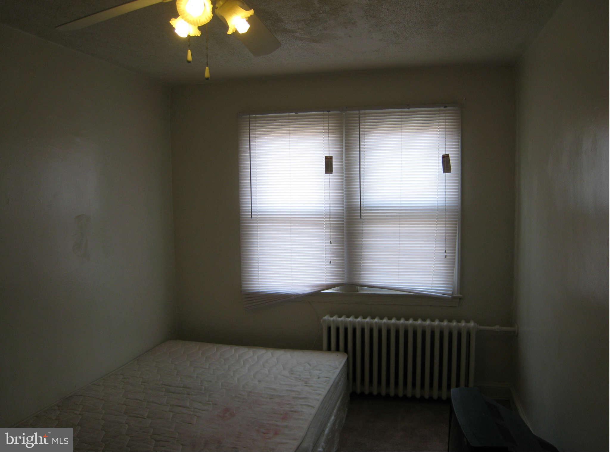 1938 I Street Northeast Washington, DC 20002 - Photo 10 of 18 a bedroom with a bed and a window