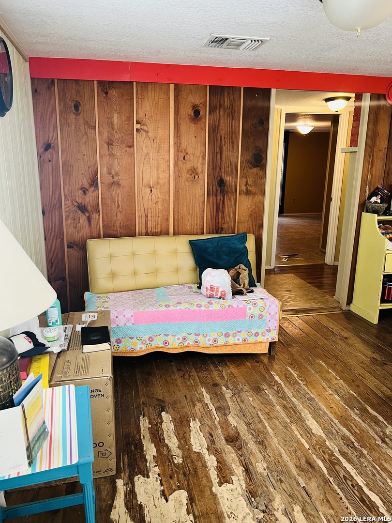 552 Diaz Street Uvalde, TX 78801 - Photo 14 of 14 a bedroom with a bed and wooden floor