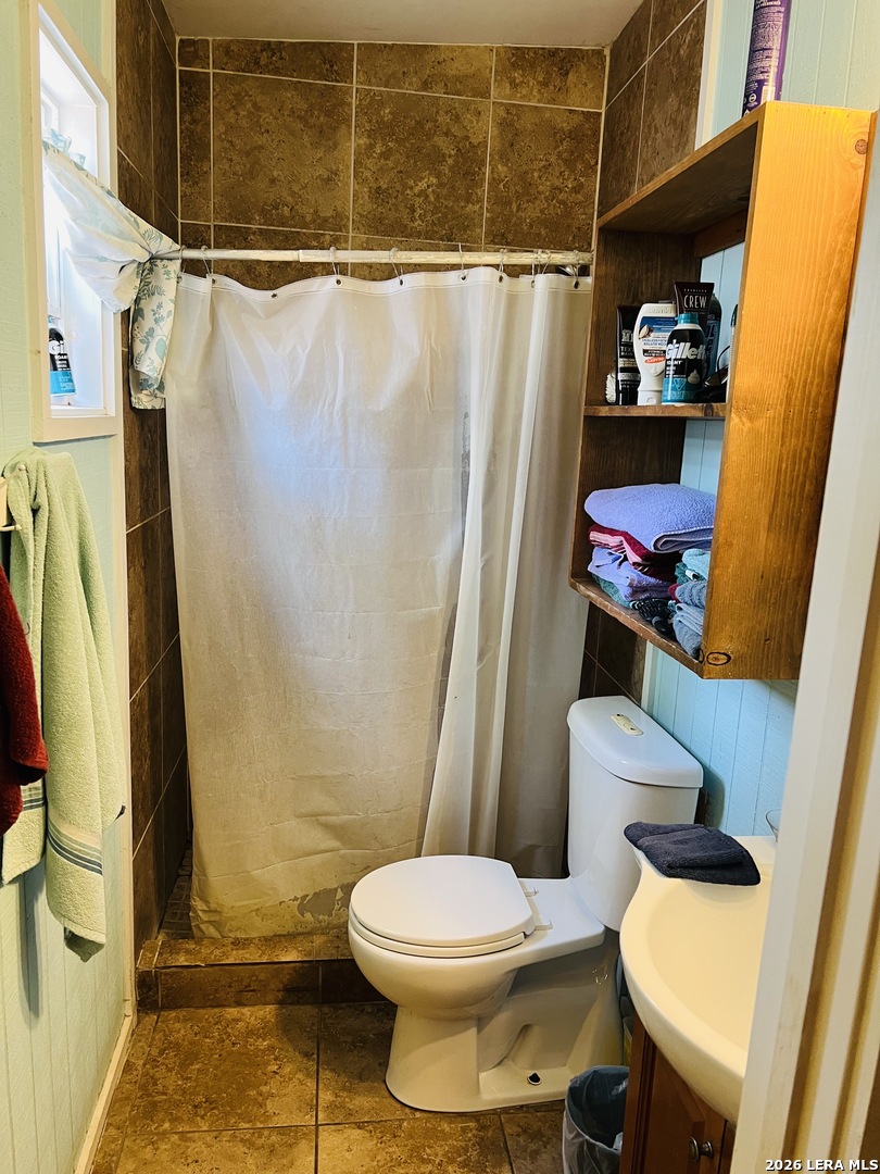 552 Diaz Street Uvalde, TX 78801 - Photo 6 of 14 a bathroom with a toilet and a shower