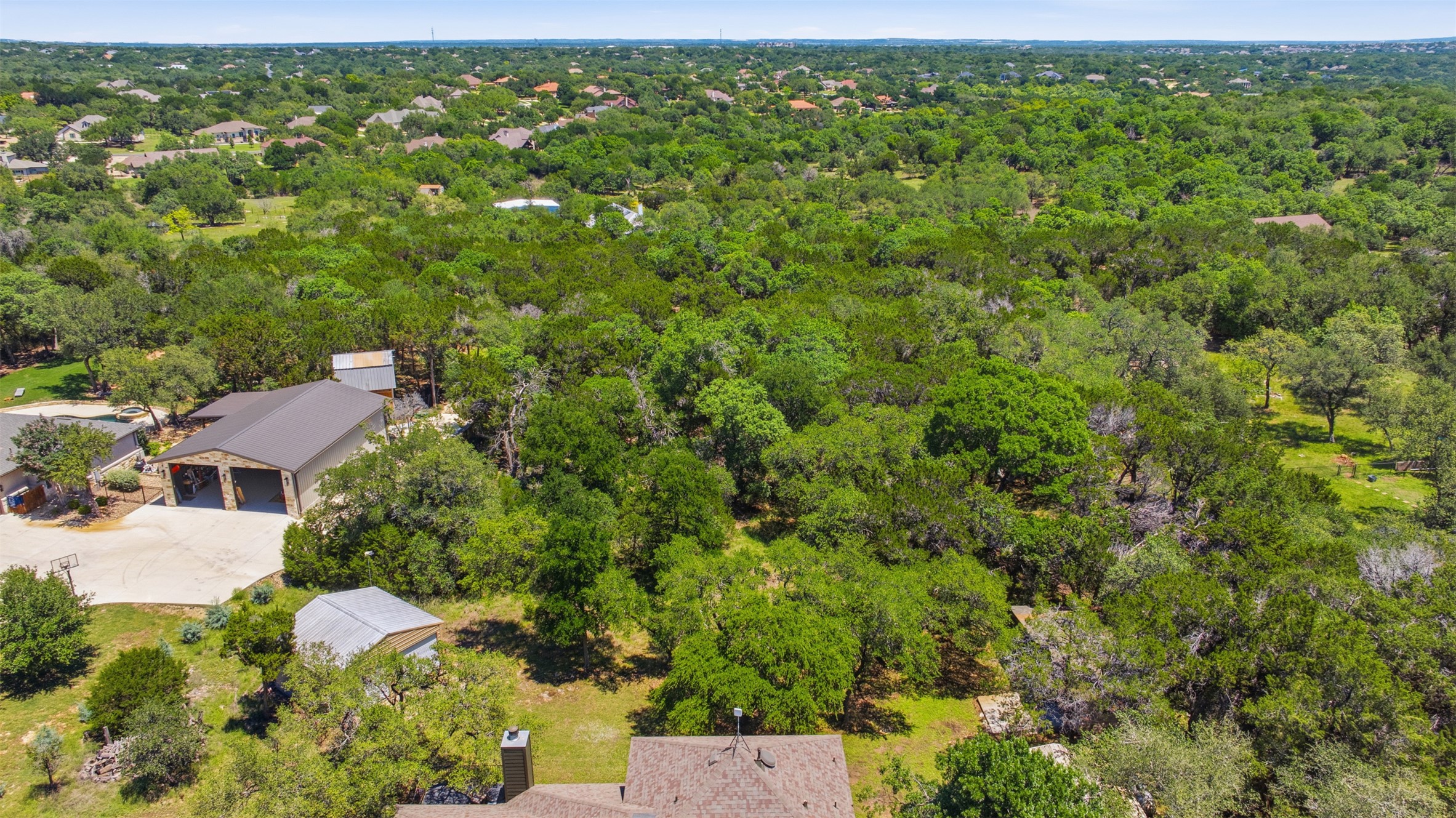 1301 County Road 262 Georgetown, TX 78633 - Photo 7 of 39 Expansive parcel featuring a large garage structure with multiple bays, a secondary utility building, and a vast expanse of mature trees