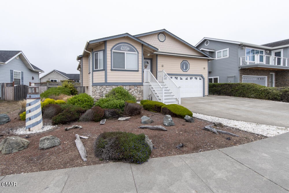 a front view of a house with a garden