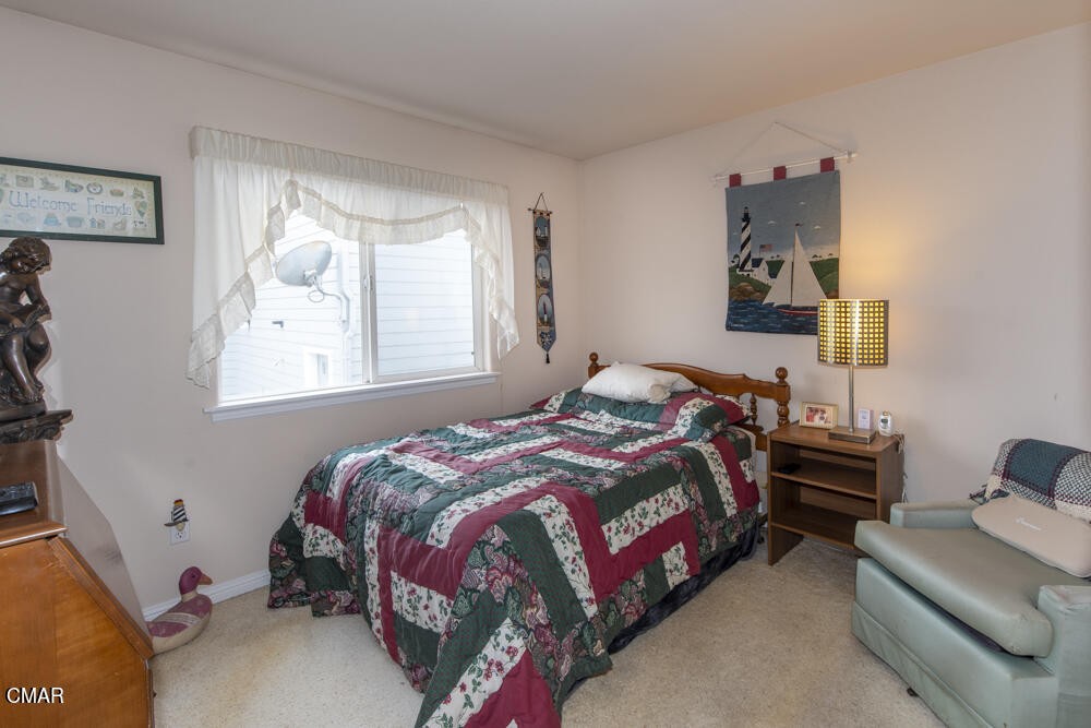 970 Glass Beach Drive Fort Bragg, CA 95437 - Photo 12 of 26 a bedroom with bed a mirror and a window
